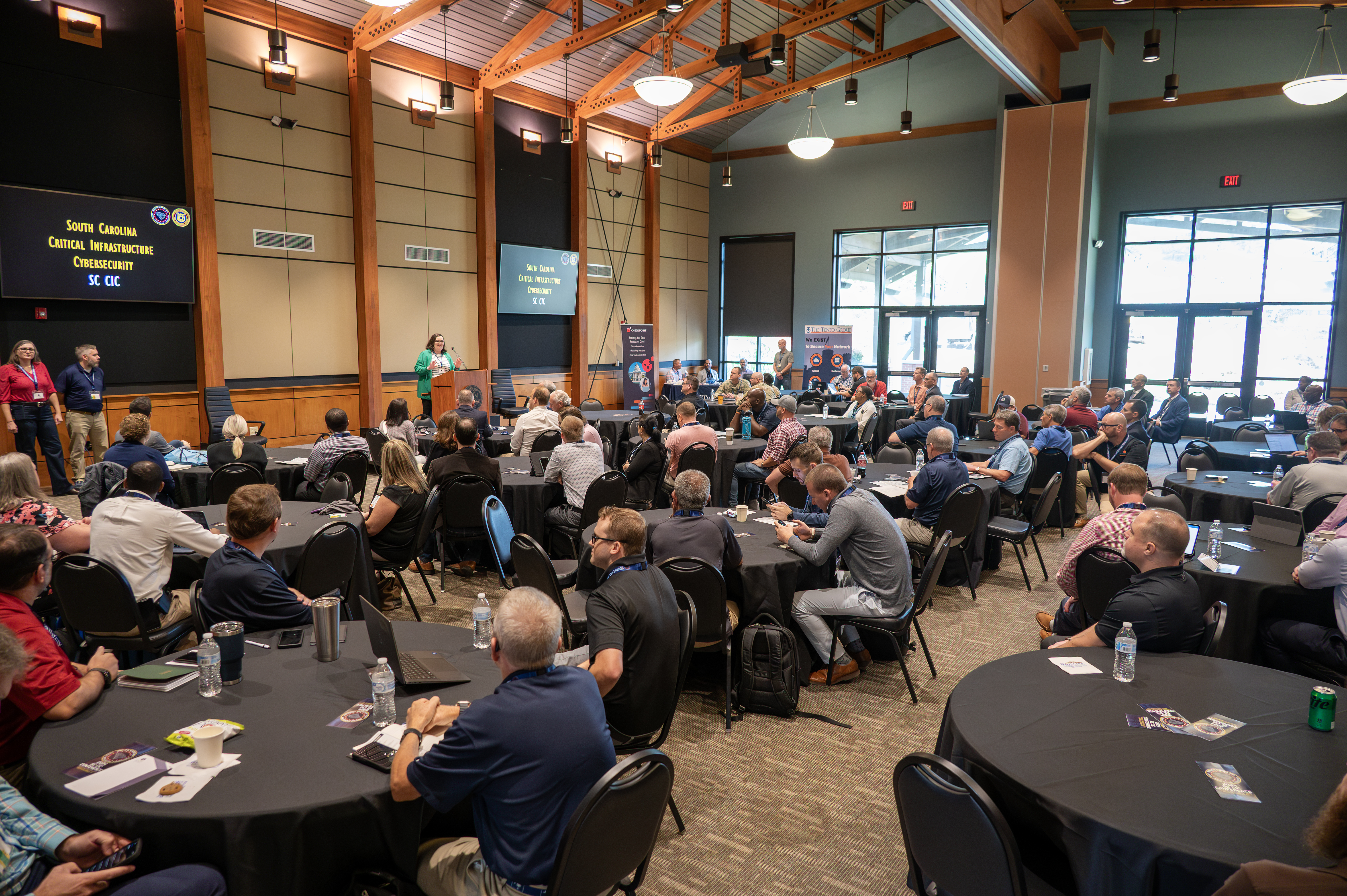 a group of people at the SC CIC conference listening to a speaker.